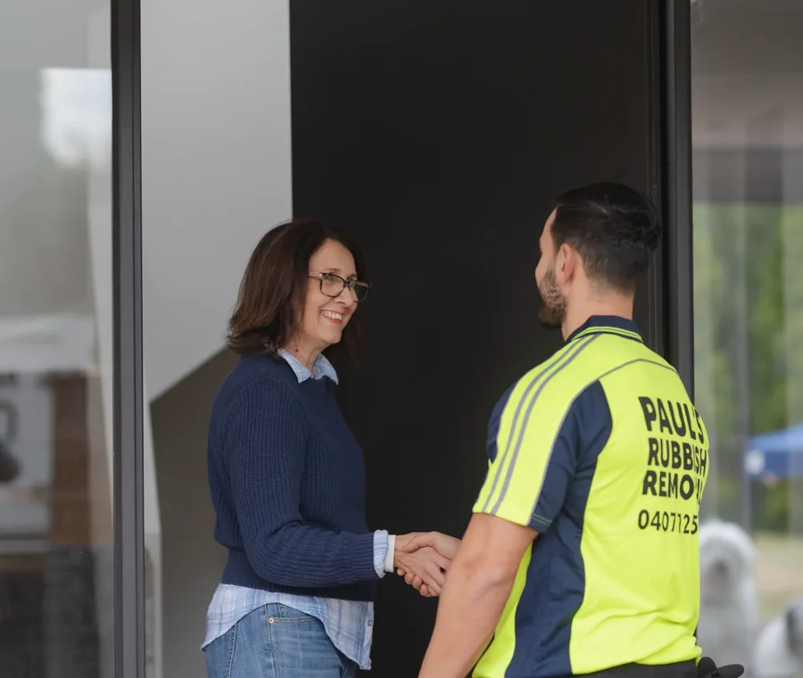 A customer greeting one of the crew at her front door